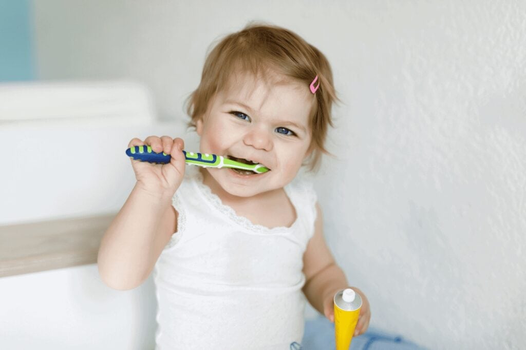 baby with toothbrush
